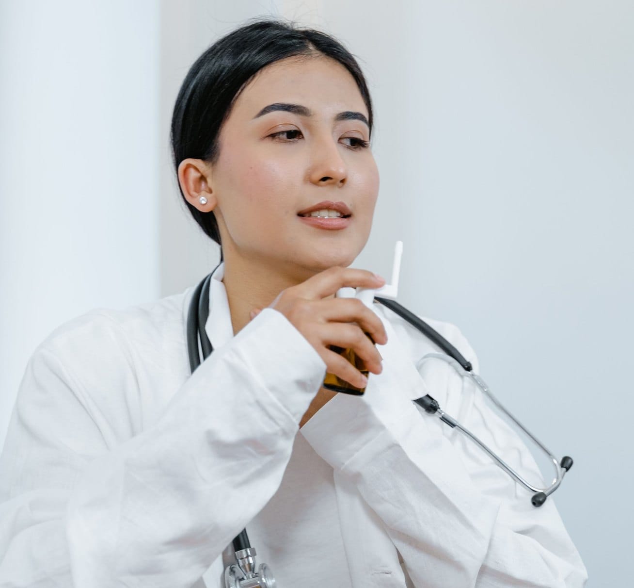A pharmacist in a white coat with a stethoscope